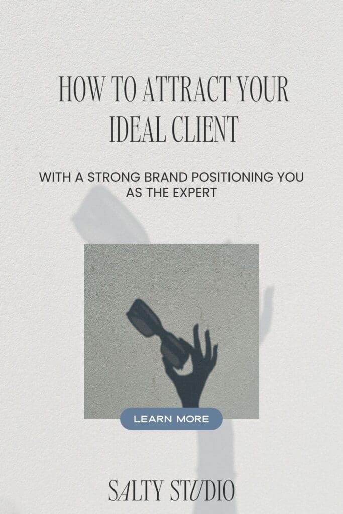 Text on a textured background reads "How to Attract Your Ideal Client." Below, "With a Strong Brand Positioning You as the Expert", a silhouette of a hand holding sunglasses is displayed. A "Learn More" button is centered at the bottom above "Salty Studio."